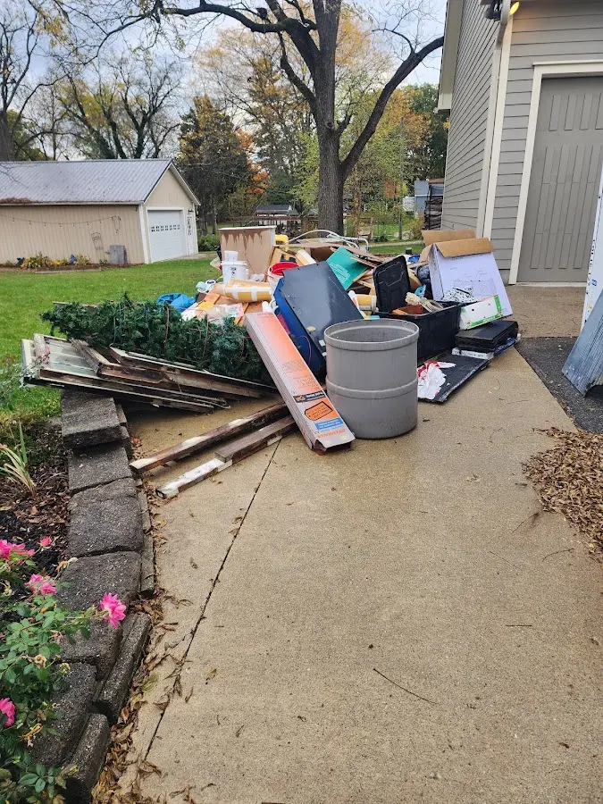 Dumpster being loaded with debris for 12 Yard Dumpster Rental in Kaser